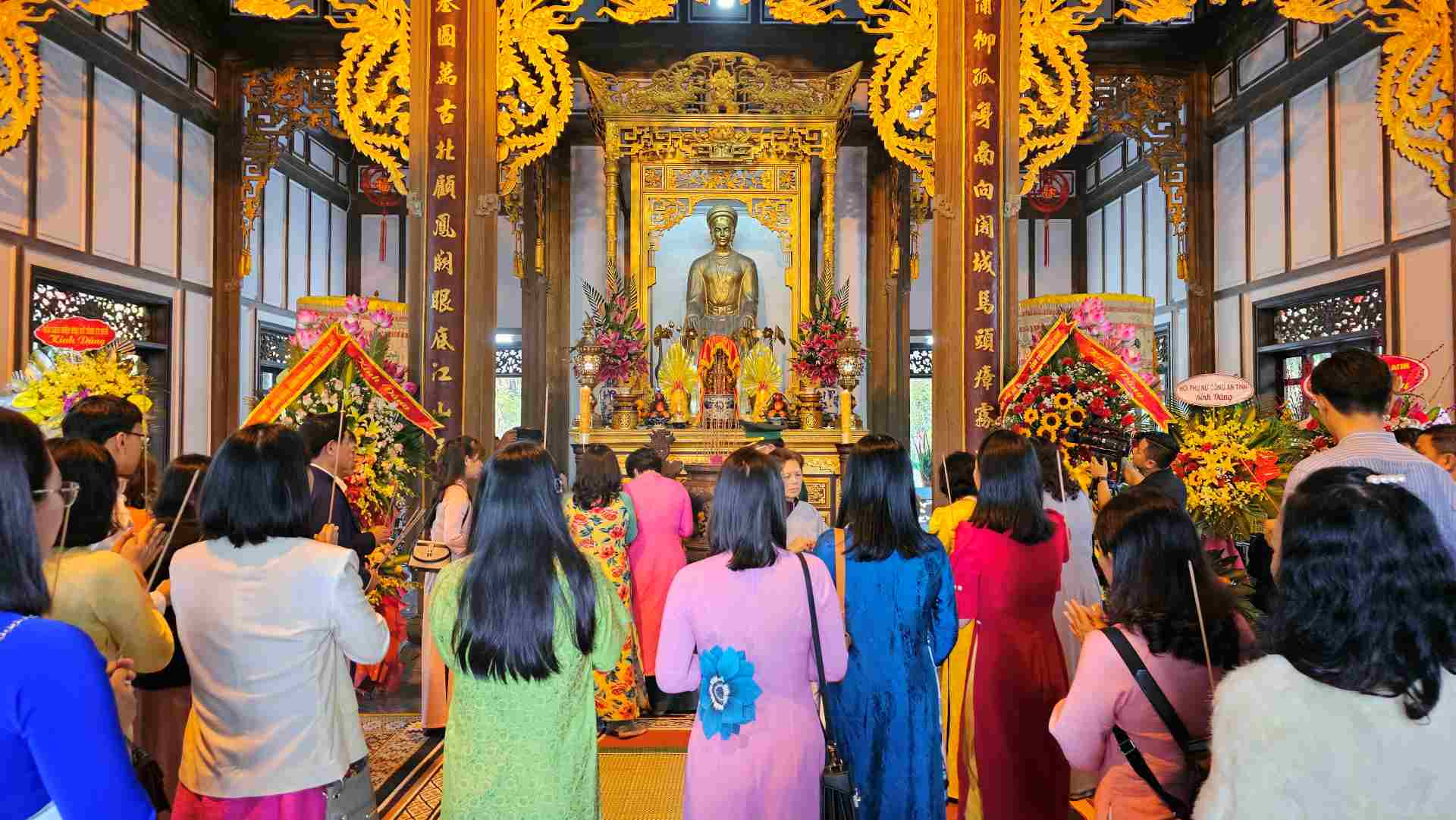 Du khách mặc trang phục áo dài thắp hương trong lễ hội